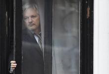 WikiLeaks founder Julian Assange comes out on the balcony of the Ecuadorian embassy to address the m