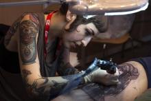 Une tatoueuse au travail lors du Mondial du tatouage, le 6 mars 2015 à Paris