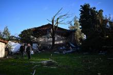 Des habitants devant un bâtiment détruit par une "mini-tornade", le 24 octobre 2022 à Bihucourt,